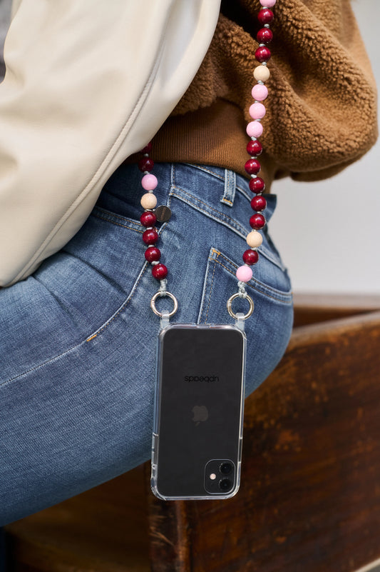 model wears around her shoulder an Autumn upbeads cellphone chain attached to it a cellphone case with rings